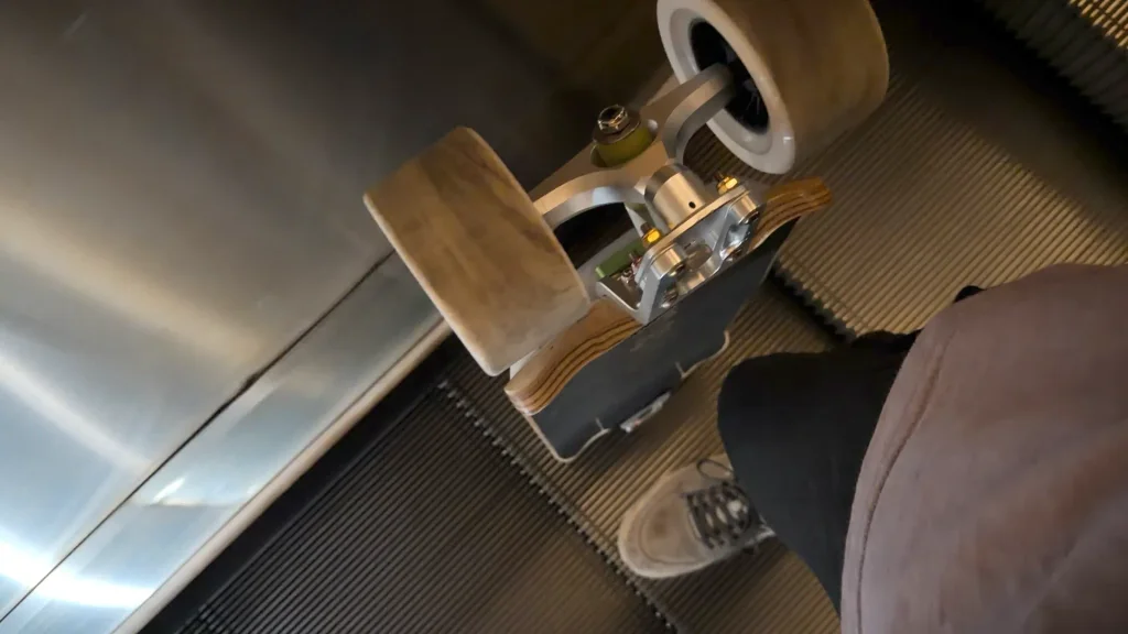 Newsesh Echo standing upright on an escalator step.