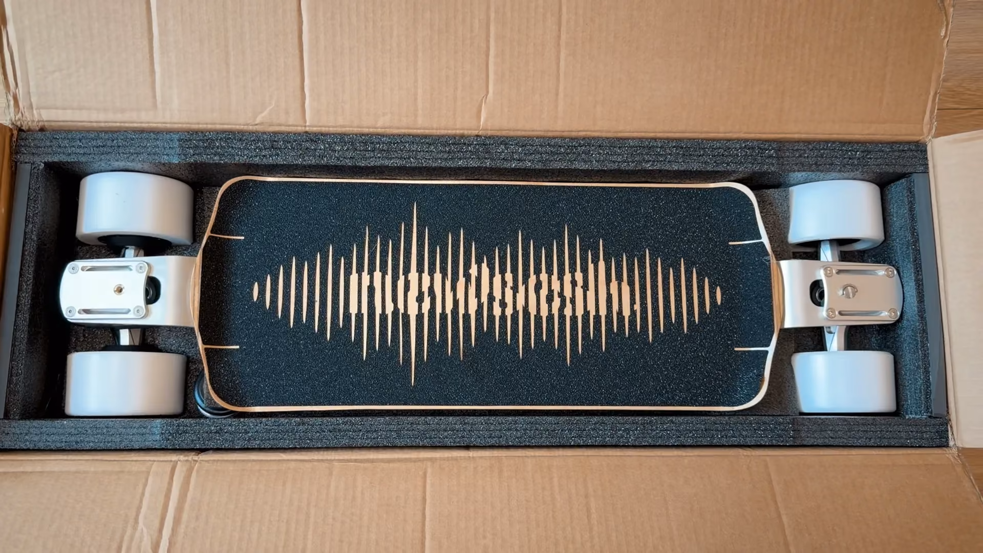 Newsesh Echo electric skateboard in its packaging.